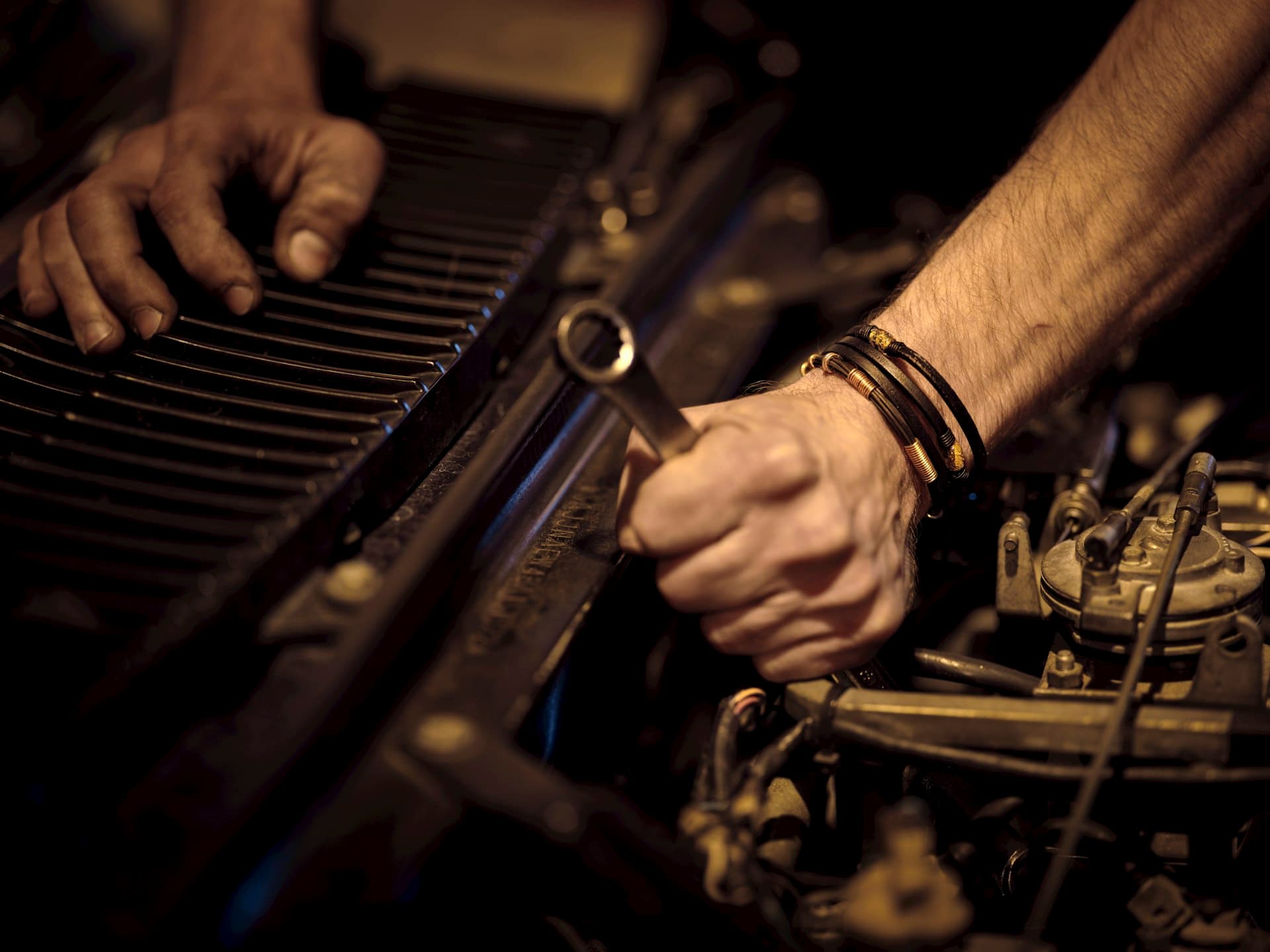 Mechanic working on car engine